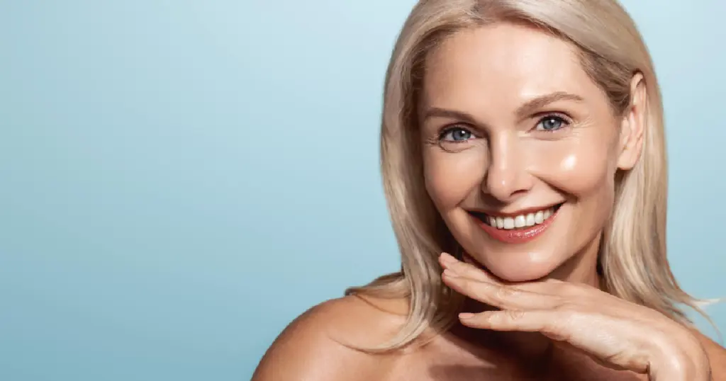 Woman with smooth, glowing skin from Epionce, and blonde hair, gently resting her chin on her hand in Vancouver, WA.
